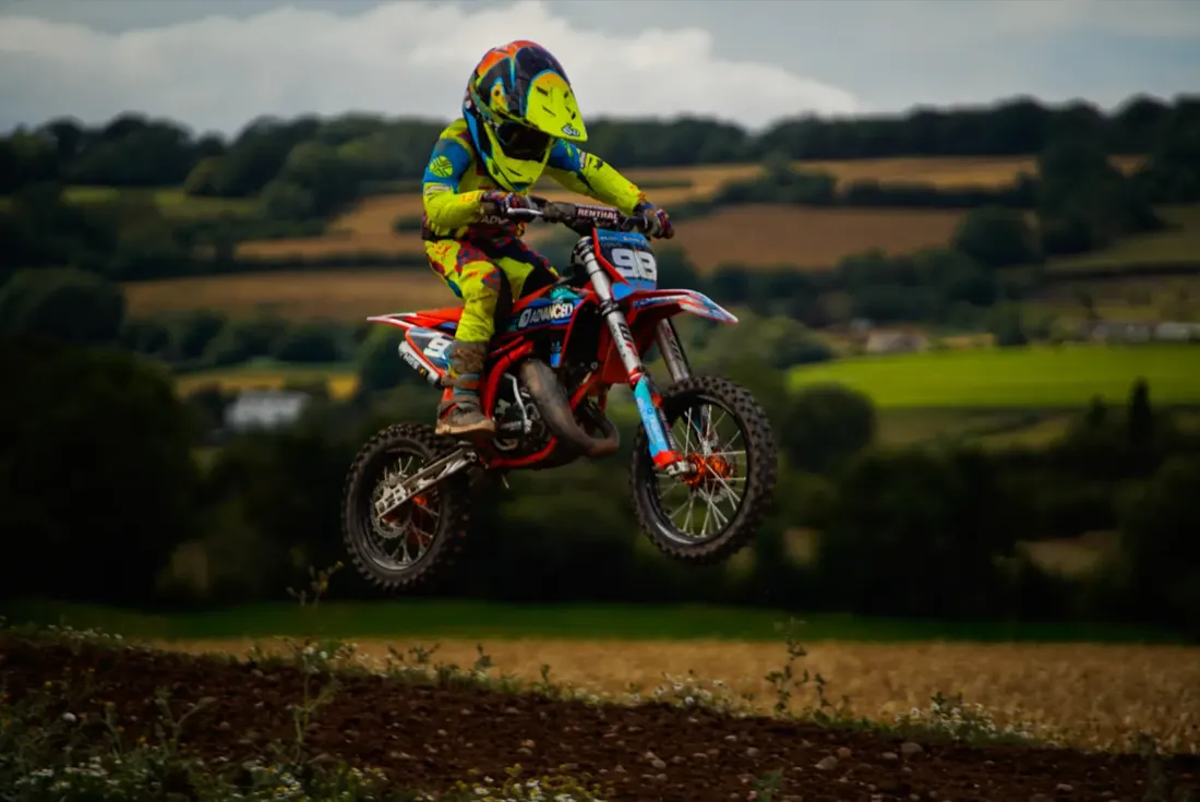 Henry Wilcox whipping his KTM over a grassy hillside