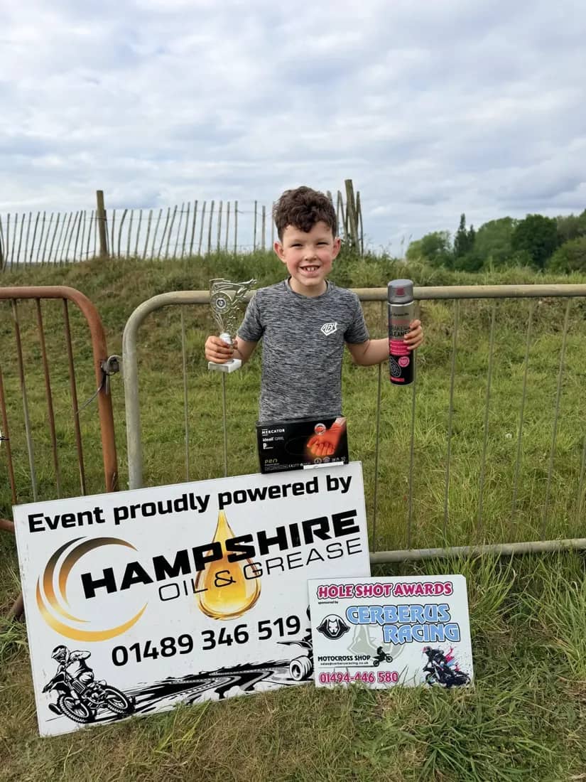 Henry Wilcox holding a trophy on race day