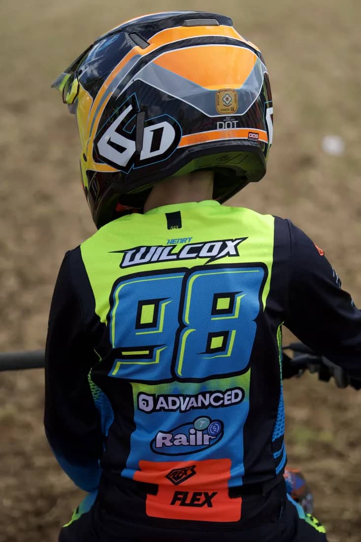 Henry Wilcox from behind, WILCOX 98 and sponsor logos on his jersey