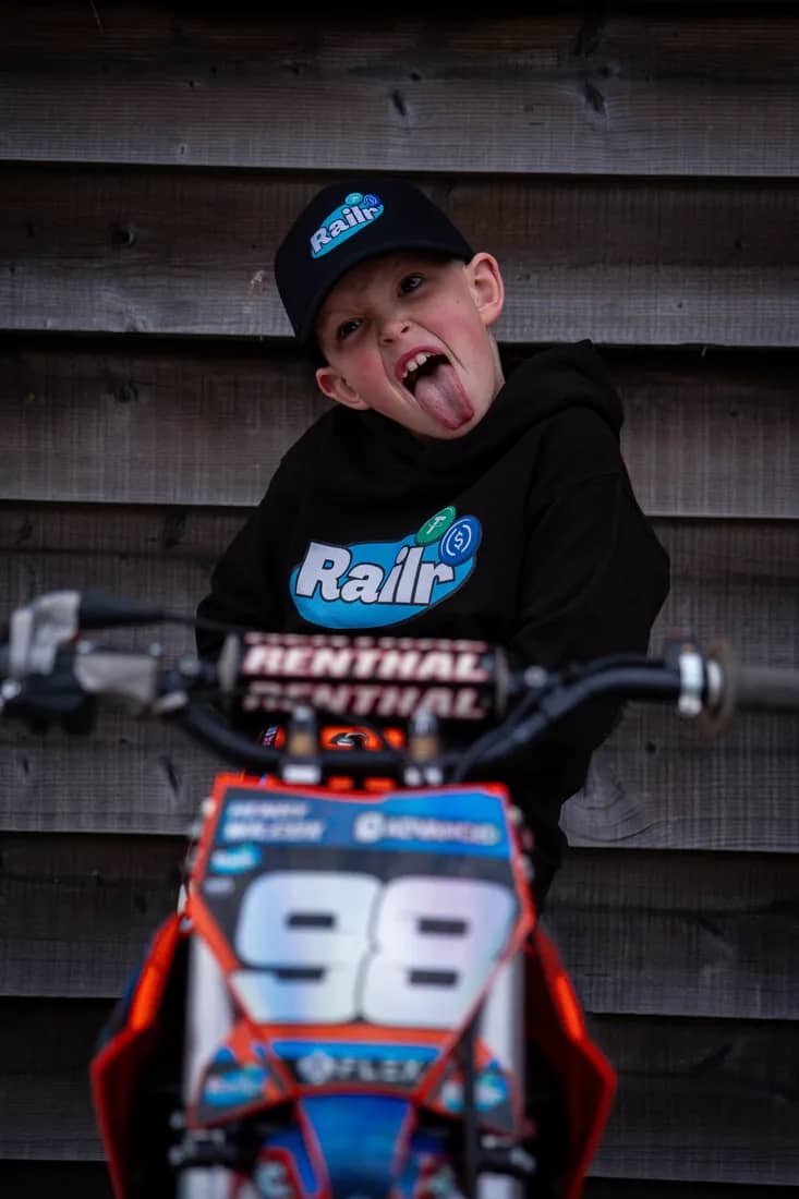 Henry Wilcox pulling a cheeky face behind his #98 bike