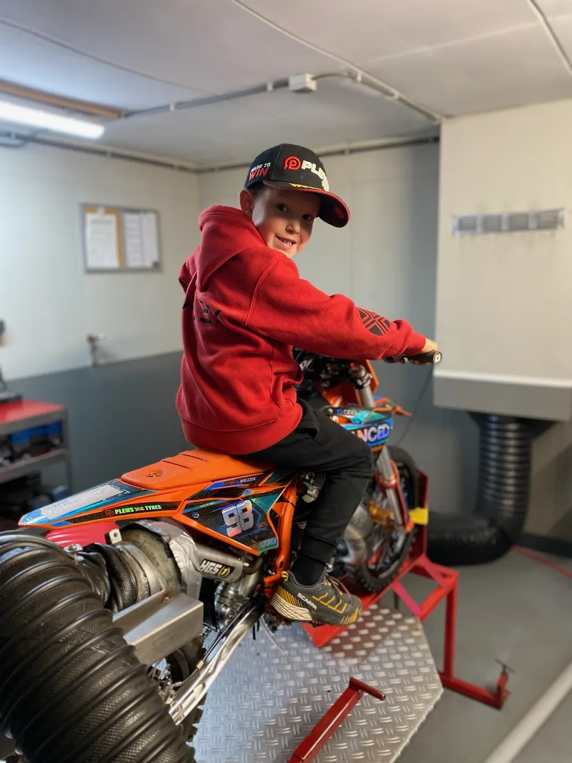 Henry Wilcox on his KTM 50 in the race trailer