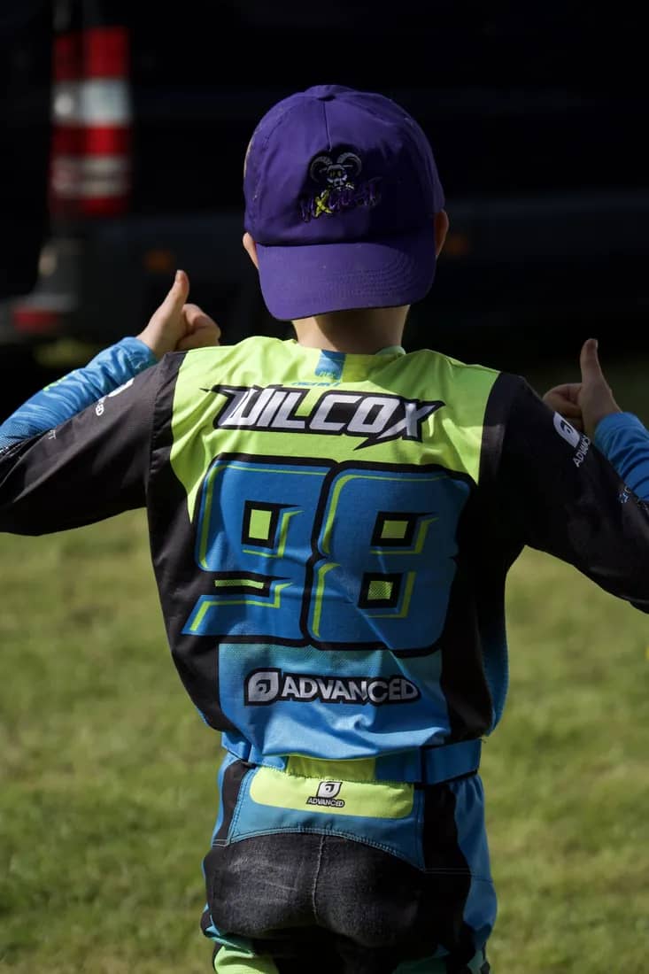 Henry Wilcox giving two thumbs up, WILCOX 98 on his back